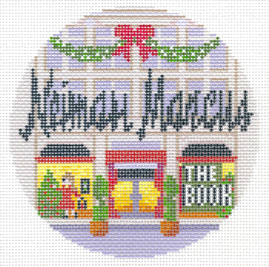 Gingham Stitchery circular needlepoint canvas featuring the words "Neiman Marcus" in dark lettering above storefront illustrations with green garlands and a red bow.