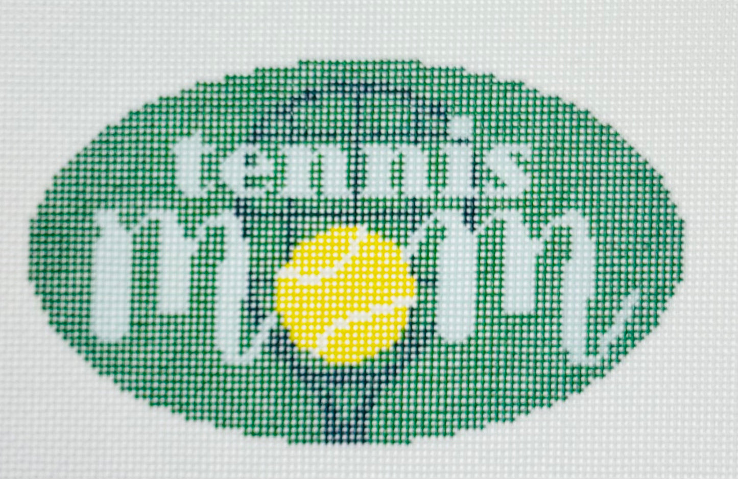 KCN Designers needlepoint canvas of 'Tennis Mom' with a tennis ball for the 'O' in 'mom' on a green background.