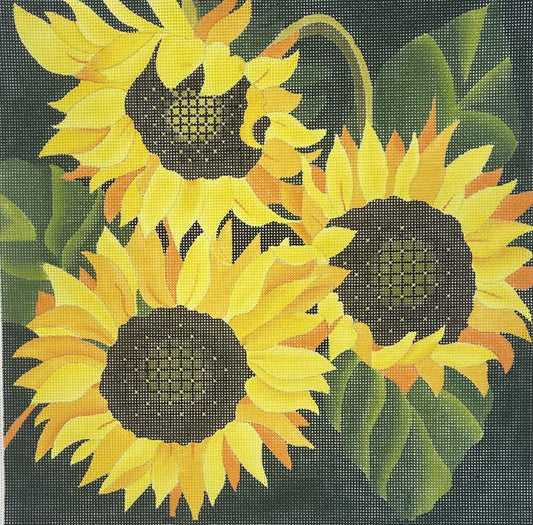 dede's needlepoint canvas featuring three yellow sunflowers with dark brown centers and green leaves on a dark background.