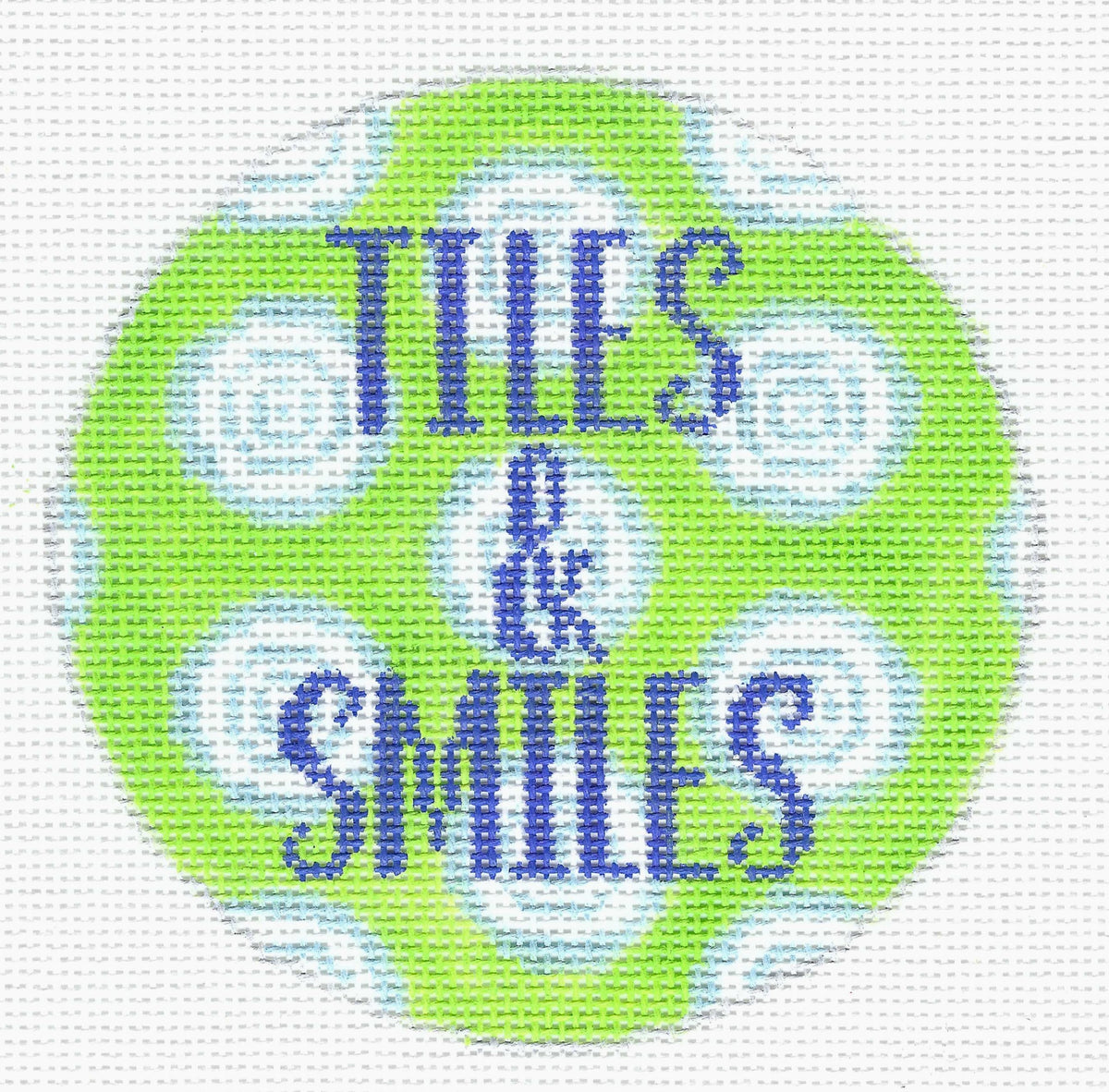 Melissa Loves Needlepoint circular needlepoint canvas with a bright lime green background, light blue and white spiral patterns, and the words 'TILES & SMILES' in blue pixelated lettering.
