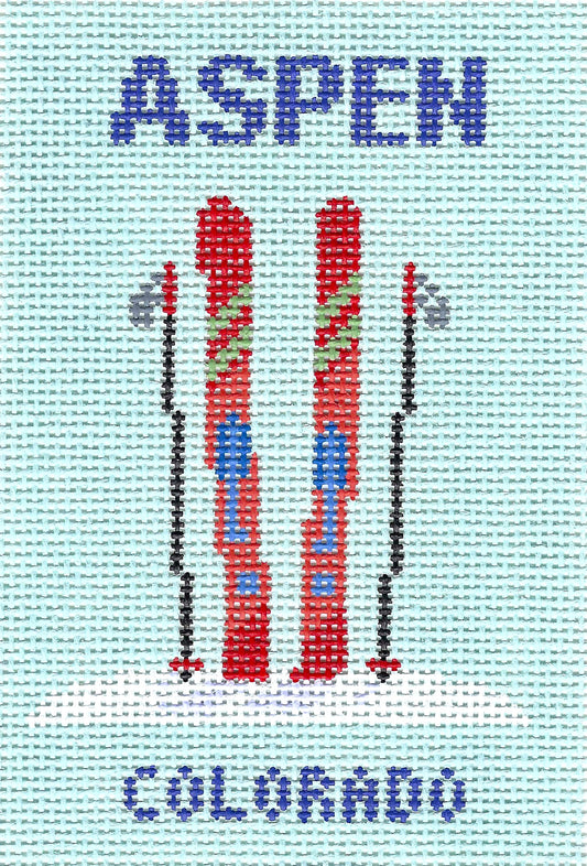 Atlantic Blue Canvas square needlepoint canvas featuring a light blue background with the word 'ASPEN' in blue at the top, two red skis in the center, ski poles, and 'COLORADO' in blue at the bottom.