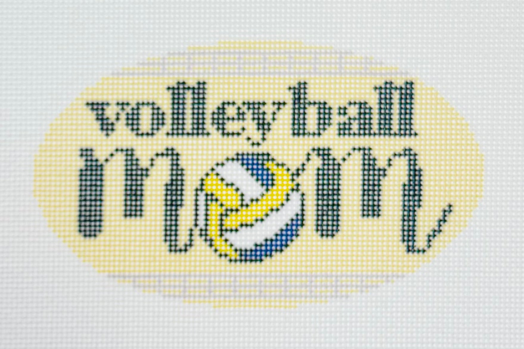 KCN Designers needlepoint canvas of 'Volleyball Mom' with a volleyball for the 'O' in 'mom' on a light yellow background.