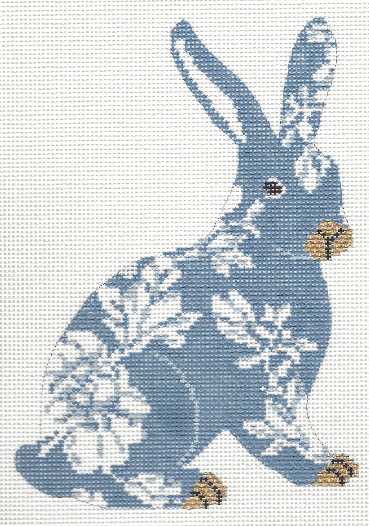 Gingham Stitchery needlepoint canvas of a blue standing bunny with white floral patterns and brown feet and nose on a white background