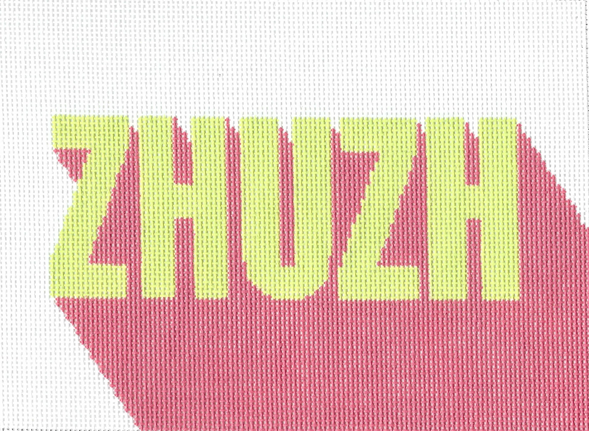 Threaded & Tipsy needlepoint canvas of the word 'ZHUZH' in light yellow-green letters over a pink shadow-like shape on a white background.